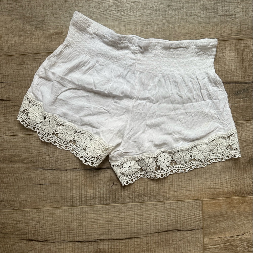 Elastic waistband. Lace trim coverup shorts.